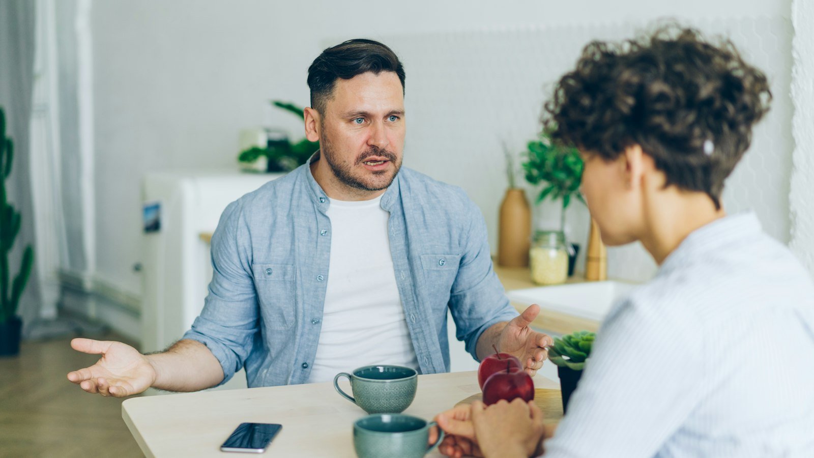 Active listening in negotiation: a man sitting at a table talking to a woman