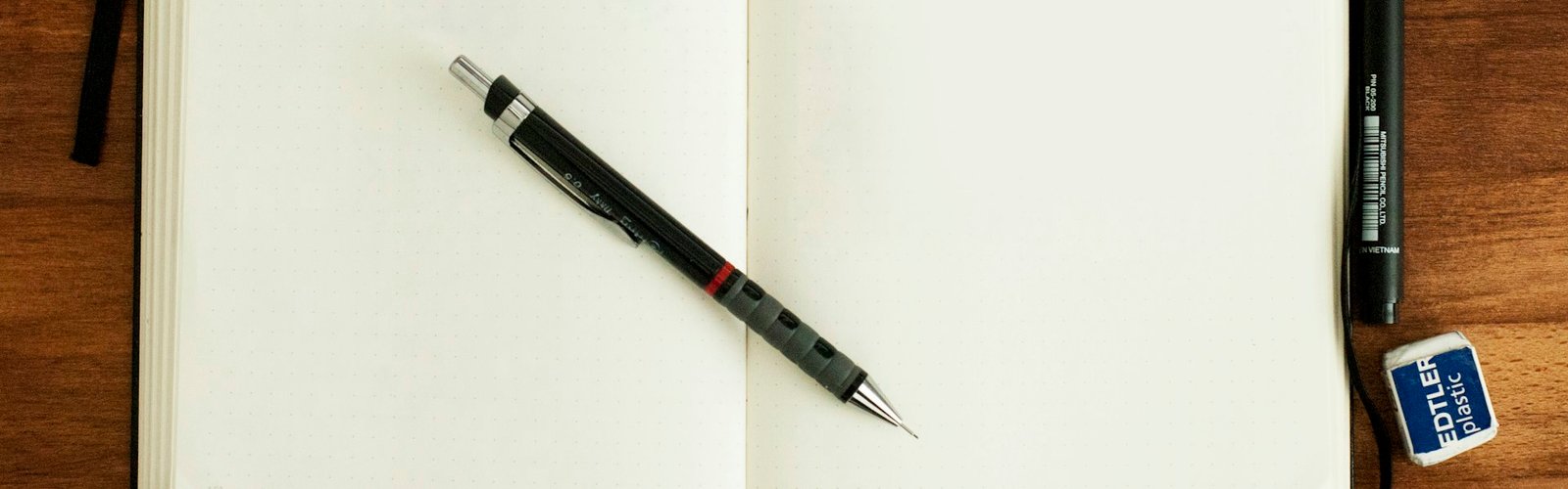 Blog post ideas for entrepreneurs: Open notebook with a pen on a desk