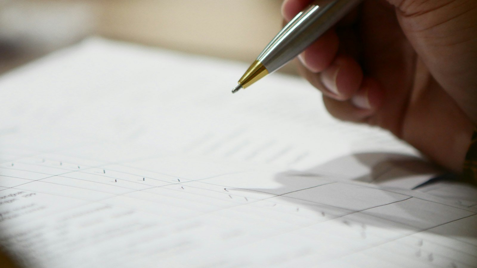 Business for sale marketplace: a hand holding a pen