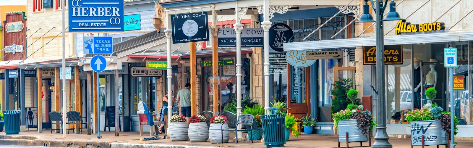 Main Street storefronts with outdoor seating on a sunny day