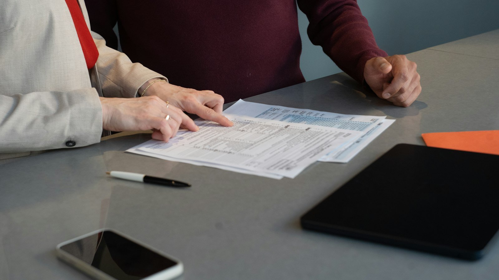 Financial statements for business buyers: Two people reviewing documents at a table