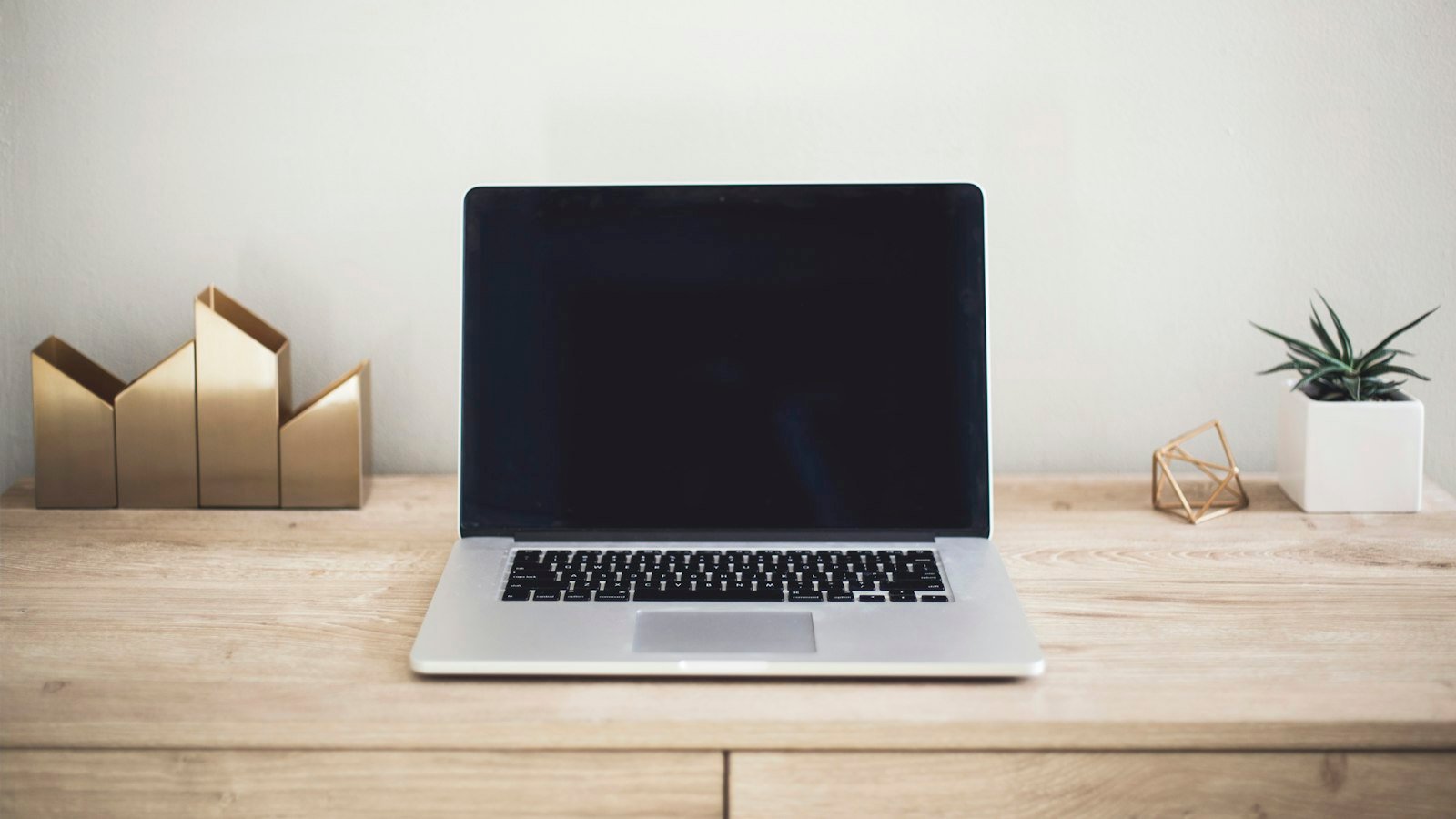 Join a partner program: MacBook Pro on top of brown table