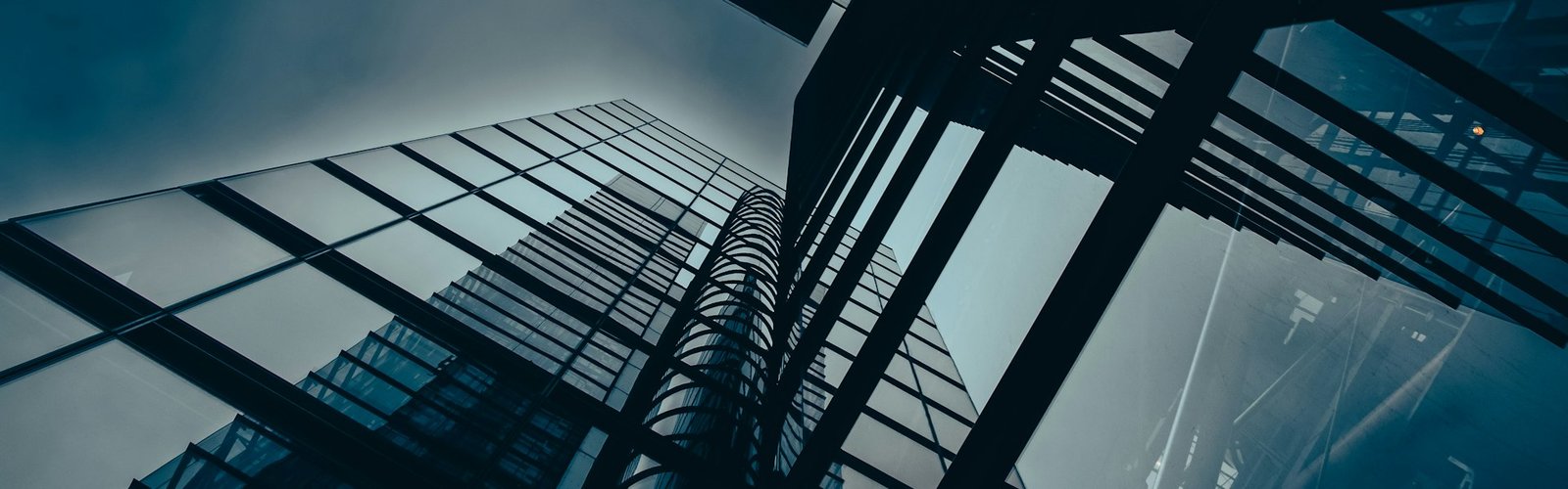 Glass corporate office tower seen from below