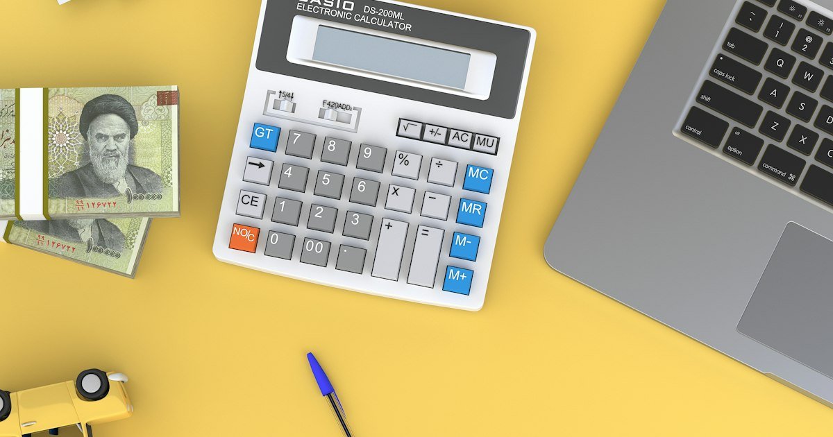 Calculator beside a laptop on a desk for planning passive income business opportunities