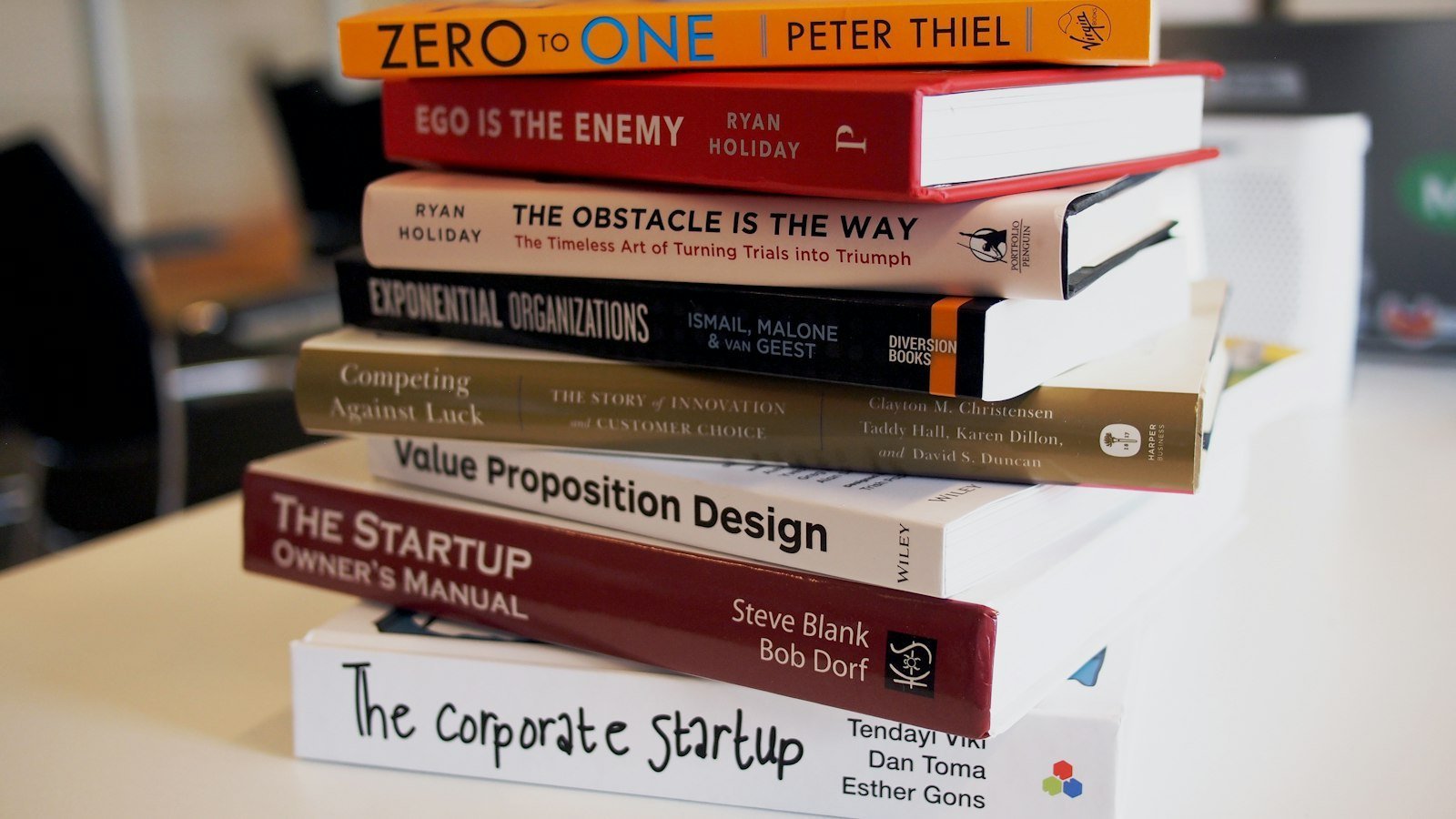 Positioning book on a desk beside a notebook and coffee