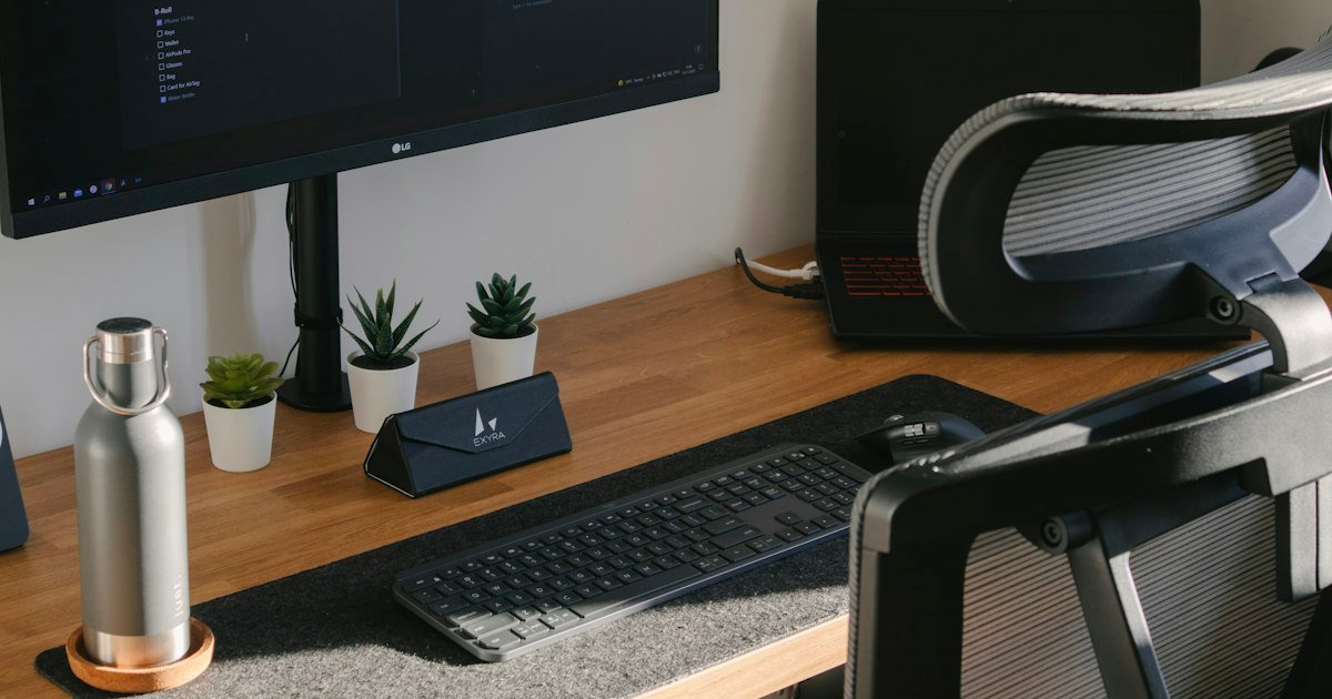 Home office desk with monitor, keyboard and plant for remote work business opportunities