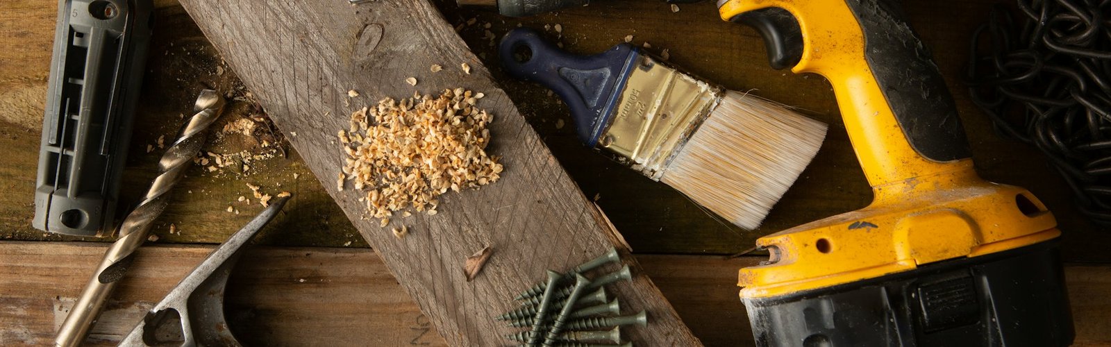 Paintbrush and wood shavings on a workbench