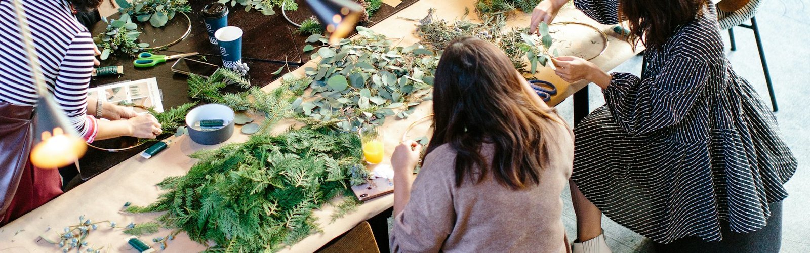 Woman browsing greenery at a craft market table
