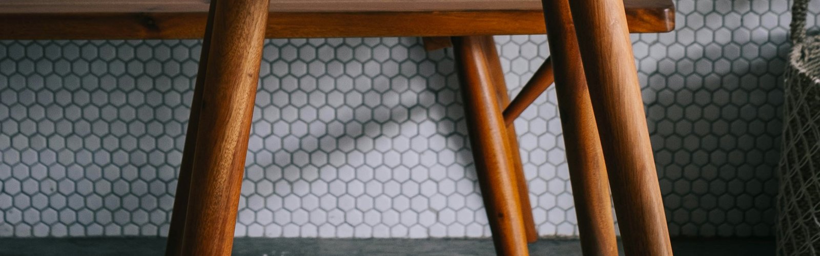 Side hustle into a business: Clear glass cup of coffee on top of a laptop at a side hustle workspace