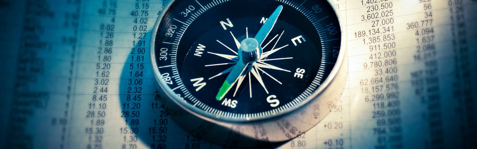 Compass resting on a map for planning direction