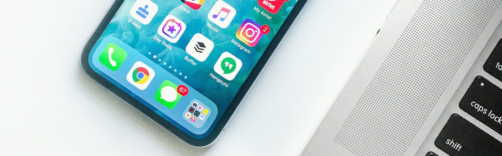 Smartphone showing app icons on a white surface