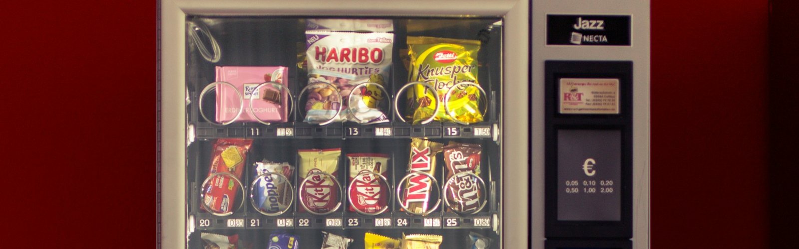 Vending machine business: Red and black vending machine in a public space